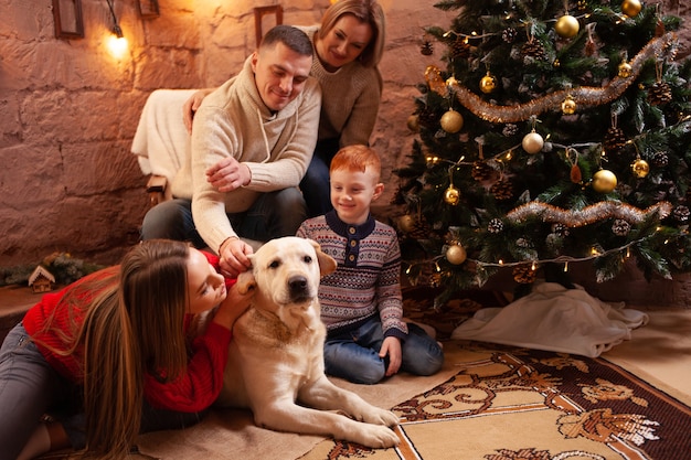 A happy family of four and a dog celebrate the New Year