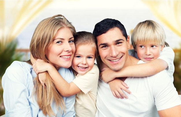 Happy family of four smiling at camera