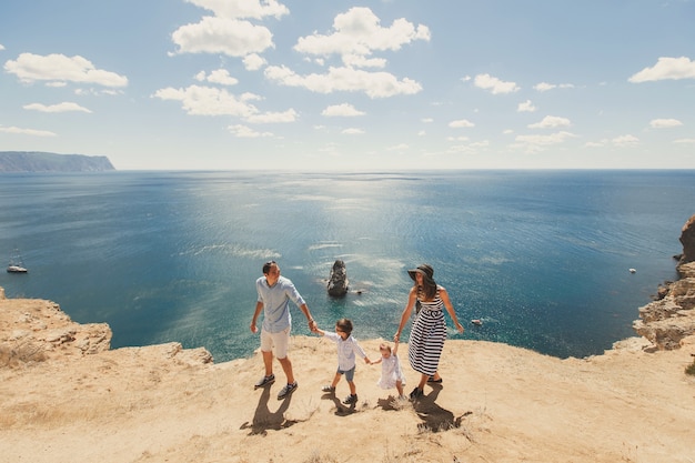 Happy family of four walking in the mountains. Family concept. Family trip.