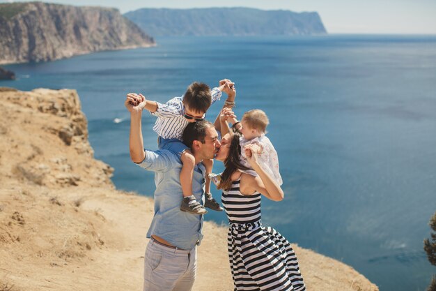 Happy family of four walking in the mountains