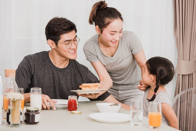 Happy family having breakfast at home