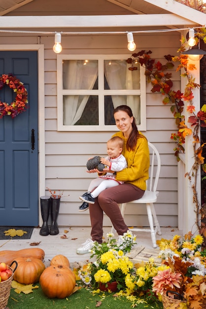 Happy family having fun in autumn near the house