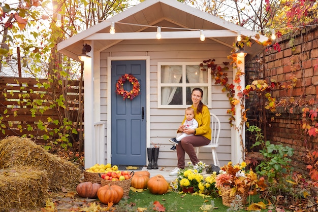 Happy family having fun in autumn near the house