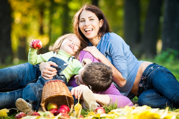 Happy family having fun in autumn park. Focus on man