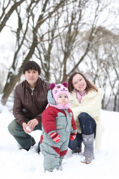 Happy family having fun on beautiful snowy winter