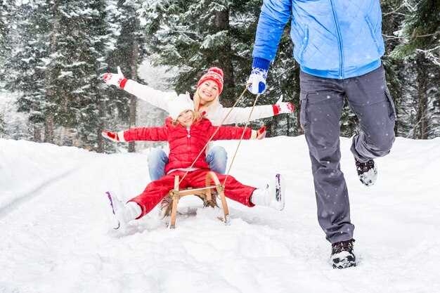 happy family having fun outdoor child mother and father playing in winter time healthy lifestyle