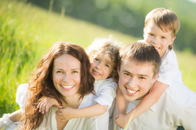 Happy family having fun outdoors in spring green field