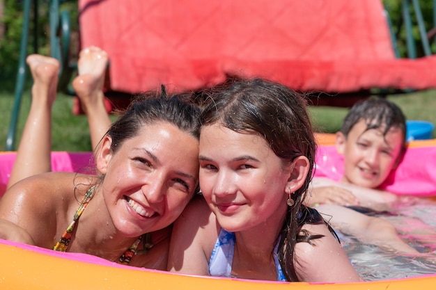 Happy family having fun in swimming pool Summertime