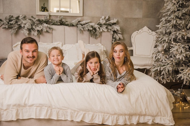 Happy family at home on the bed New year concept