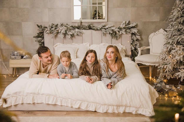 Happy family at home on the bed New year concept