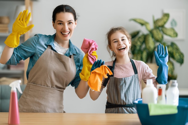 Happy family at home Mother and daughter doing the cleaning in the house