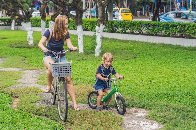 Happy family is riding bikes outdoors and smiling