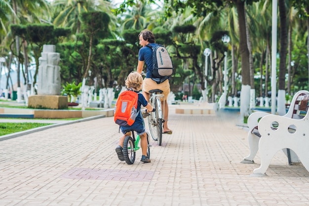 Happy family is riding bikes outdoors and smiling