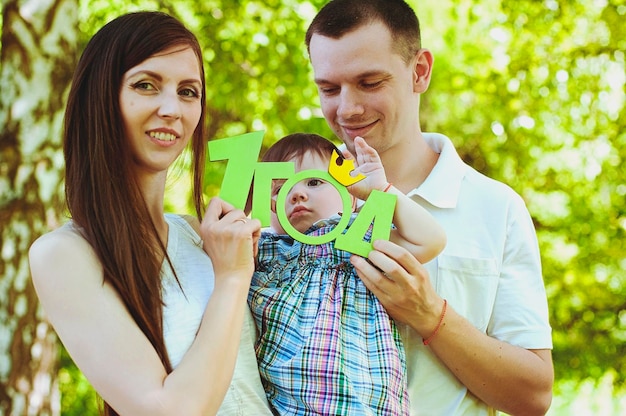 Happy family lifestyle and holiday. Mother, father, little girl sitting, walking in city, park