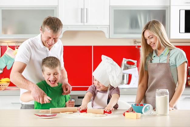 Happy family making pizza in kitchen