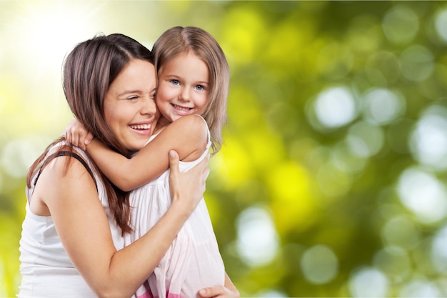 happy family. Mother and baby daughter plays, hugging, kissing at home on the sofa