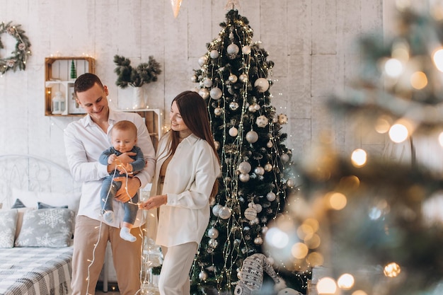 happy family mother, father and child. Christmas tree