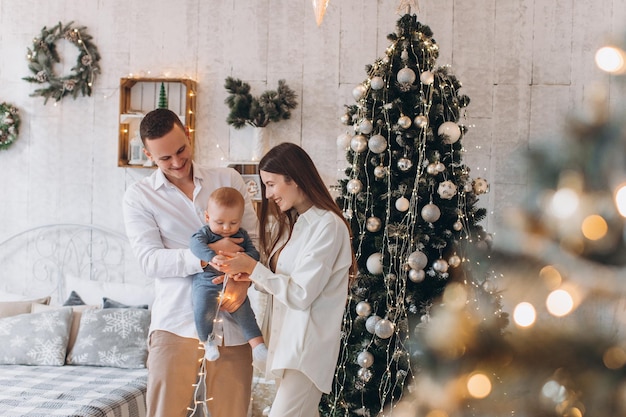 happy family mother, father and child. Christmas tree