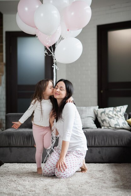 Happy family multiethnic mother father and son laughing playing and rejoicing in pajamas