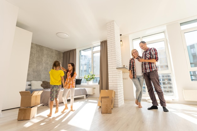 Happy family in a new house. Real estate and moving background.