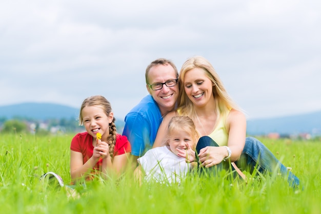 Happy Family outdoors sitting on grass