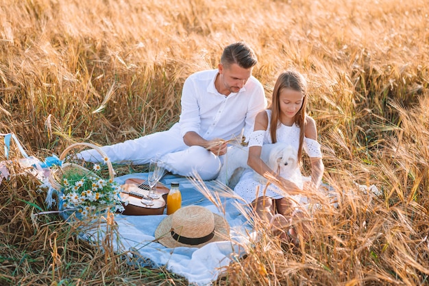 Happy family playing in a wheat field