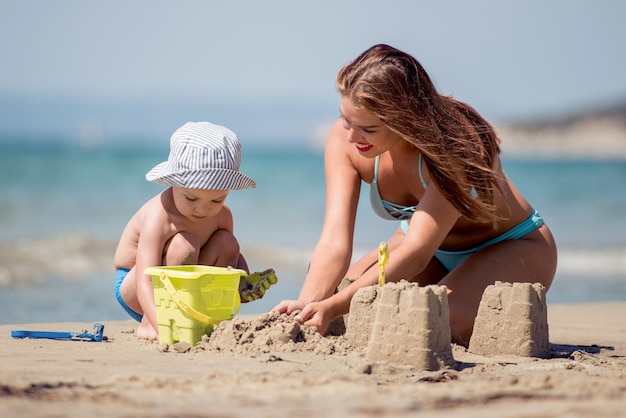 Happy family playing with sand