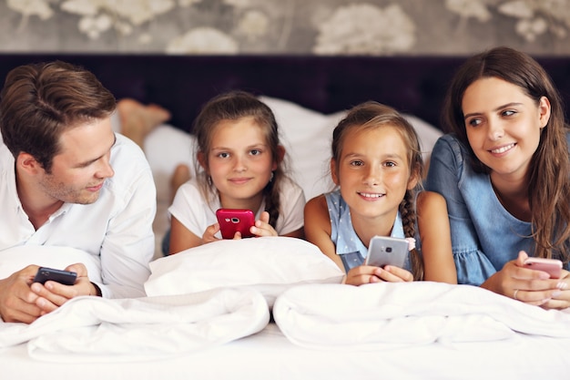 happy family relaxing in hotel room