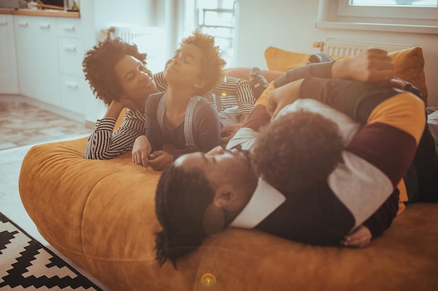 Happy family relaxing on the sofa together at home