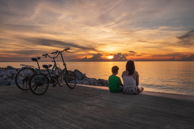 Happy family resting at beach in summer. mother with boy resting on the beach.