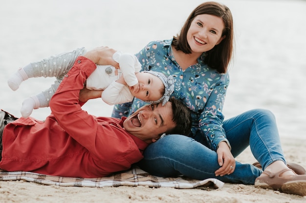 Happy family resting by the lake