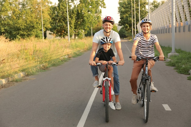 Happy family riding bicycles outdoors