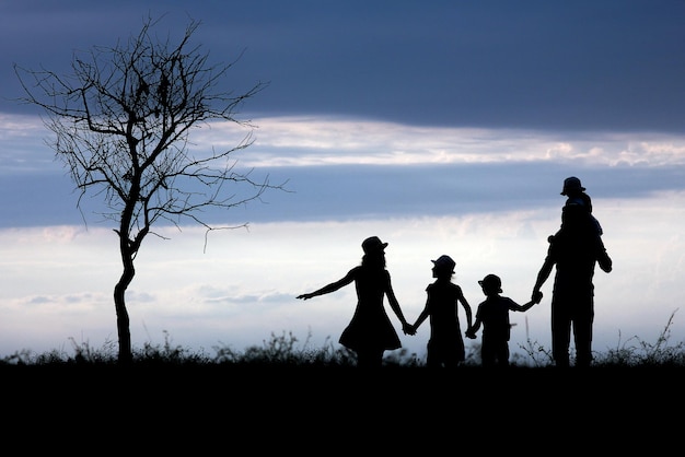 A Happy family silhouette on nature in park background