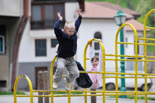 Photo happy family sister and brother have fun and play games outdoor in park