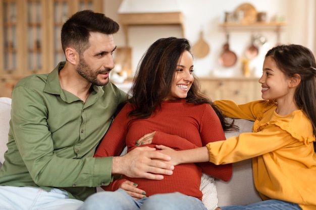 Happy family sitting on the sofa together