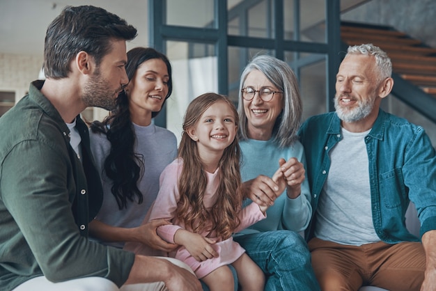 Happy family spending time together and smiling while sitting on the sofa at home