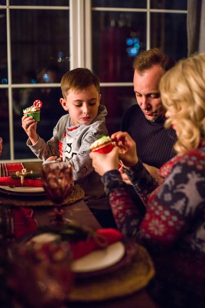 Happy family at the table on new year's eve