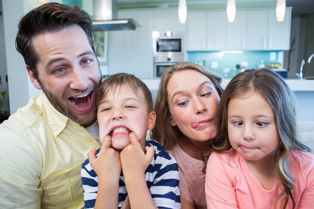 Happy family taking selfie on couch