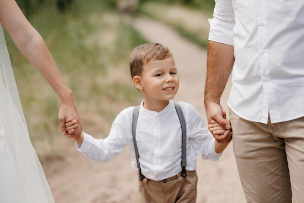 Happy family three dad mom and son on a walk