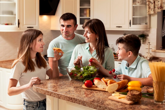 Happy family together in the kitchen preparing food