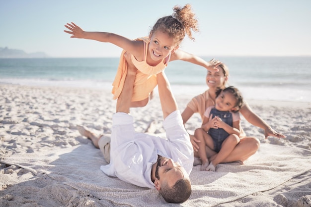 Happy family travel and beach holiday with children and parents playing in sand together Love nature and mother and father bonding with playful girls on an ocean trip relax outdoor on vacation