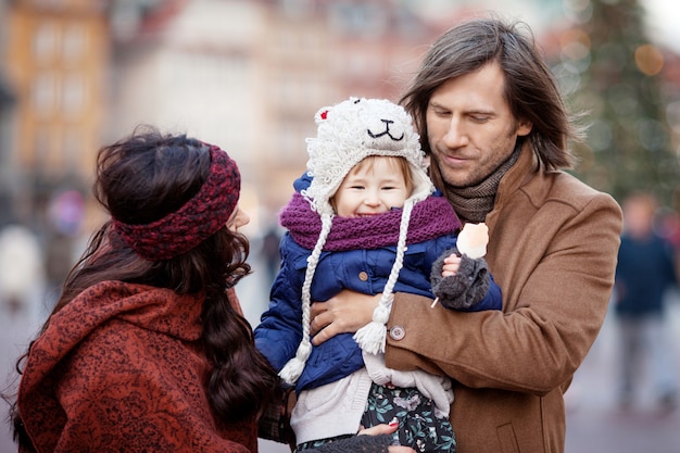 Happy family walking in autumn city and having fun