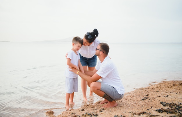 Happy family walking on the beach