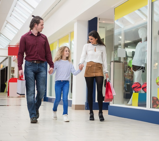 Happy family walking with shopping bags