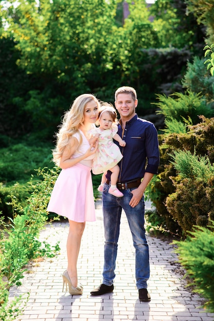 Happy family walks in the Park. Dad mom and daughter.