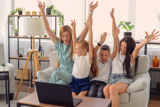 happy family watching movie together on laptop at home happy together