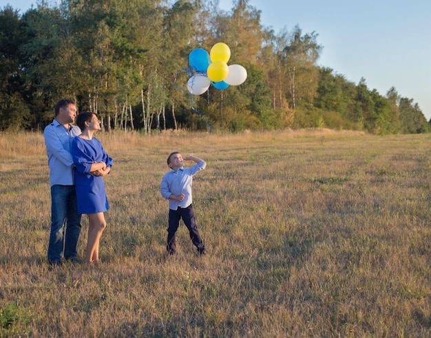 Happy family with balloons outdoor