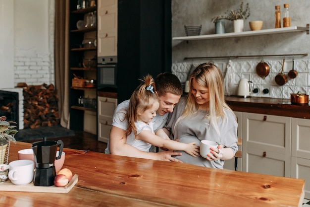 Happy family with a child cooks and laughs in the kitchen