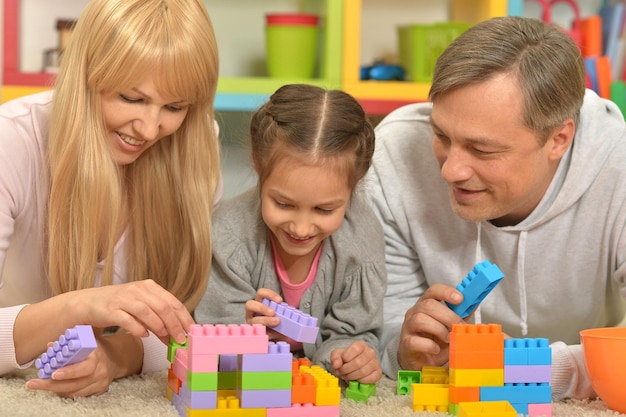 Happy family with children playing with toy blocks