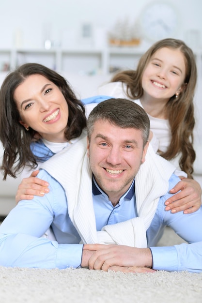 Happy family with daughter lie embracing